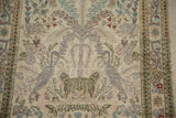 Close-up of the pictorial lovebirds and blossomed tree motif on a vintage Tabriz rug.