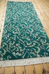 Long view of the Indian runner's carved, serrated leaf pattern in jade and teal.
