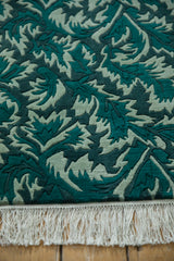Shallow carved pile with a serrated leaf pattern in jade and forest green, with white fringe.