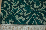 Shallow carved contour detail of green serrated leaves and cream fringe on the Indian runner.