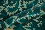 Shallow carved contour and plush pile on a William Morris design rug in dusty teal and jade.