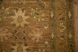 The Peshawar rug's even, short pile with floral palmettes in wheat and oxidized silver.