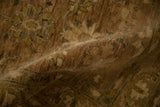 Dense hand-knotted texture and short, even pile of a Peshawar rug in sandalwood tones.
