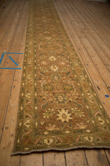 Long angled view of the Peshawar rug runner's repeating palmette and vinery pattern.