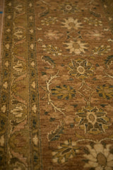 Angled detail of a Peshawar runner showing the sandalwood floral field and patterned border.