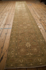 Low-angle view of the long Peshawar rug runner showing its traditional floral pattern.