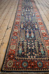 Hand-knotted Pakistani Bakhtiari runner: navy field with Samovar plants and brick red floral border.