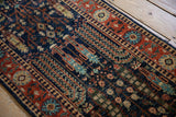 Vintage Pakistani Bakhtiari runner detail, navy blue field with Samovar plants and brick red floral border.