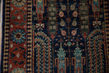 Hand-knotted Bakhtiari field: dusty navy, teal Samovar plants, brick red border detail.