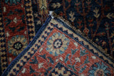 Hand-knotted Bakhtiari runner corner, showing secure side cord, fringe, and intricate palmette design.