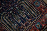 Hand knotted Bakhtiari rug's brick red floral border, reciprocating palmette, and navy cypress field.