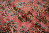Blush pink Kerman carpet pile with delicate sky blue and celadon floral sprays.