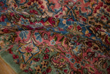 Vintage Kerman rug's plush pile featuring blush, blue, and celadon green floral motifs.