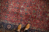 Vintage Indian Agra carpet featuring brick red field, navy blue border with Samovar and Islimis motifs.