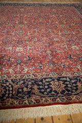 White fringe, navy blue border with scrolling vinery and thousand flower motifs.