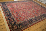 Traditional vintage Agra carpet field with brick red arabesque and navy Islimis border.