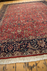 Ivory fringe and navy blue border with scrolling vinery on a vintage Agra carpet.