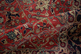 Textural close-up of vintage Agra carpet with brick red, navy, and green curvilinear Islimis.