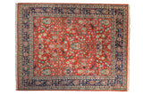 Vintage Indian Bijar design carpet with a scrolling rose pattern on a red field and navy border.
