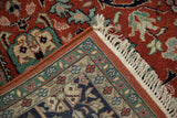 Folded corner of a vintage Indian Bijar carpet showing the dense pile, floral border, and fringe.