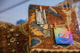 Detailed pile of antique Kerman rug fragment in cochineal red and sapphire blue floral design.