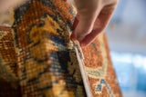 Hand pinning into antique Kerman fragment cork board, cochineal red and sapphire blue.