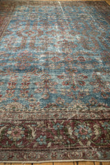 Aqua blue field of vintage Mahal carpet with repeating floral motifs and soft patina.