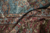 Folded detail of hand knotted vintage Mahal carpet, showing aqua blue and burgundy floral motifs.