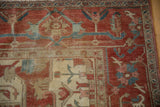Samovar main border detail on an antique Serapi carpet in terracotta, blue, and sea foam green.