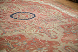 Angled view across the low-pile field of an antique Serapi with serrated floral motifs.