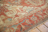 Close view of the Samovar border on an antique Serapi with terracotta and powder blue florals.