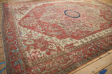 Antique Serapi carpet's expansive geometric design in terracotta, ivory, and blue.