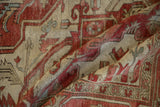 Textured wool pile and serrated terracotta motifs of a late 19th-century Serapi carpet.