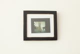 A square handmade wall art frame in black with a vintage-style finish.