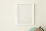 Sleek white handmade wall art frame featuring a slender, flat profile and mat.