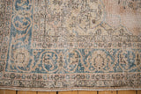 Distressed Sparta rug border, dusty teal arabesque vine, and faded rose tones.