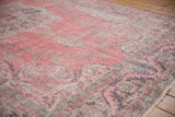 Distressed texture of vintage Sparta carpet with faded pink and charcoal floral vinery.