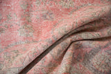 Pale mauve, beige, and charcoal distressed vintage Sparta carpet, highlighting geometric patterns and worn pile.