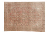 Distressed vintage Isparta carpet, decorative geometric medallion, dusty rose and soft beige hues.