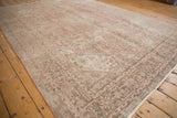 Vintage distressed Turkish Isparta carpet, visible low pile with faded rose and brown traditional motifs.