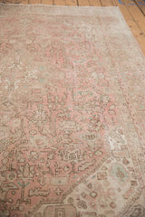 Distressed Isparta carpet showing faded geometric patterns, palmettes in dusty rose, beige.