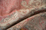 Distressed vintage Turkish Sparta carpet with pale cochineal red and silver curvilinear design.