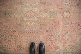 Detail of a vintage distressed Isparta rug with worn dusty rose field and muted floral motifs.