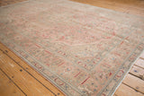Distressed Isparta carpet corner detail, showing even wear, dusty rose and pale beige patterns.