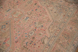 Vintage Isparta carpet segment with distressed low pile and dusty rose, aqua patterns.