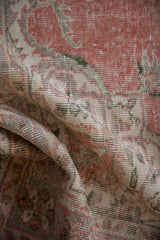 Vintage Distressed Sparta rug showing worn pile and muted rose, beige colors.