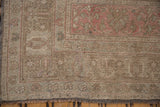 Distressed Oushak carpet corner, revealing even pile wear, faint foundation, and muted beige and pink tones.