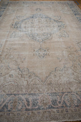 Distressed pile texture of a vintage Turkish Sparta carpet with dusty blue and pale pink patterns.