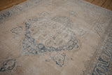 Distressed vintage Sparta carpet's texture, showing faded dusty blue and ivory patterns.