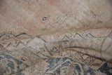 Texture of distressed vintage Sparta carpet, showing worn pile, exposed foundation, and faded blue details.